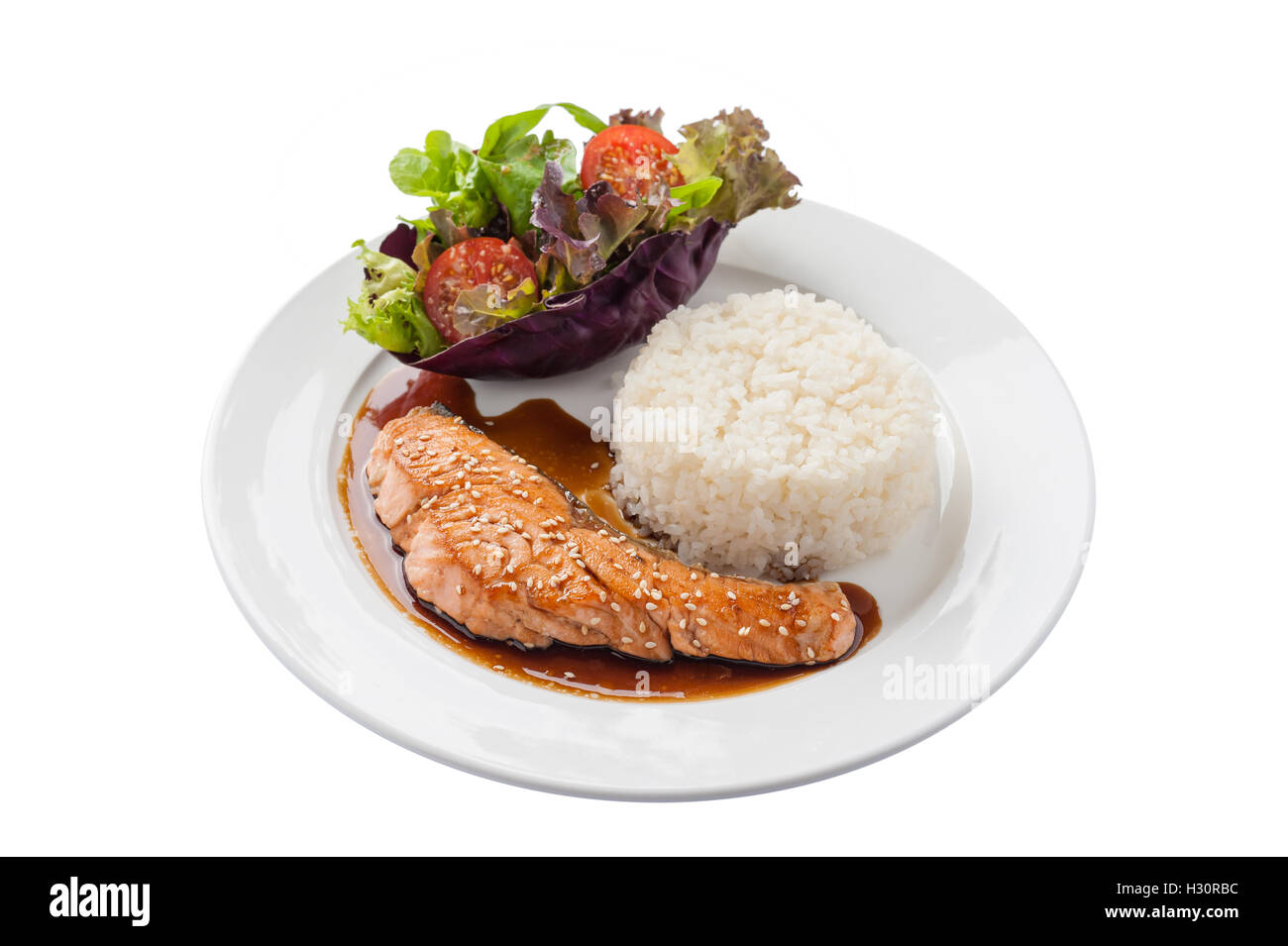 Front view of Fusion food style grilled salmon dressed with Japanese sweet sauce (Teriyaki) including Thai rice garnished with v Stock Photo