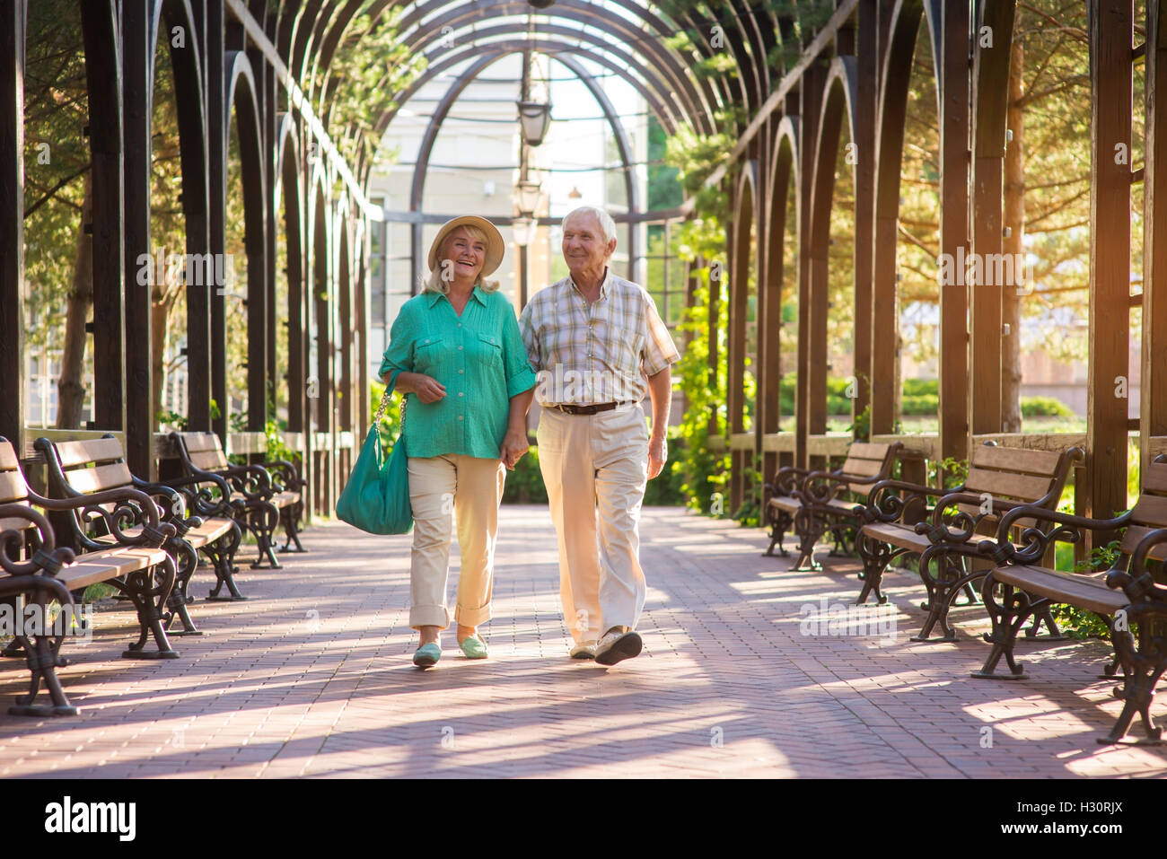 Senior couple walking and smiling Stock Photo - Alamy