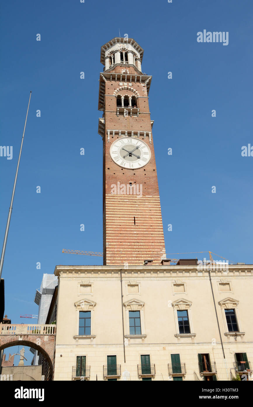 Verona, Italy - September 3, 2016: Torre dei Lamberti tower on Piazza Delle Erbe square in Verona, Italy. Unidentified people vi Stock Photo