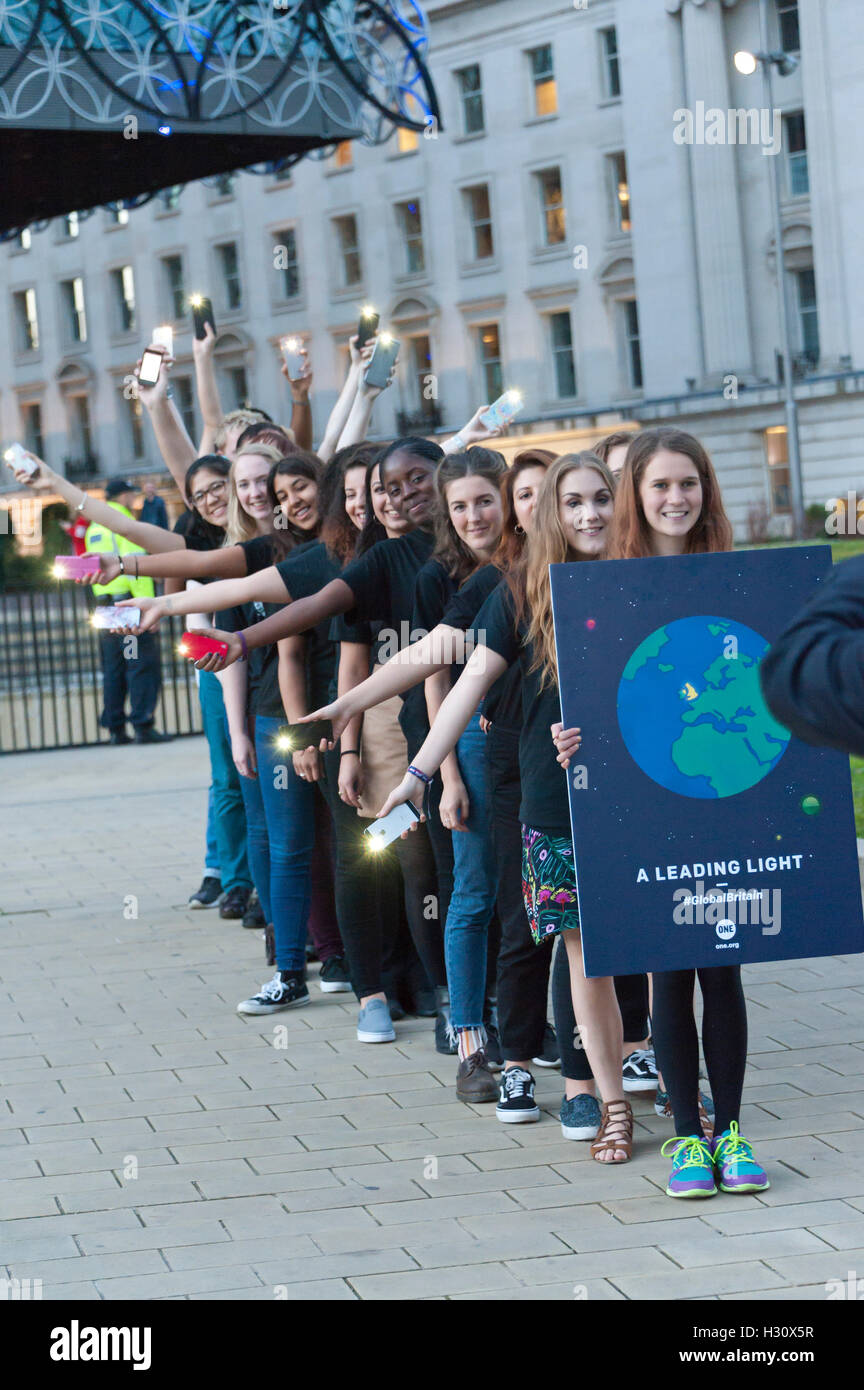 Birmingham, West Midlands, UK. 2nd October 2016. 'One' an advocacy group which campaigns for world governments to fight corruption and extreme poverty get together for a photo call outside the venue of the annual Conservative Party Conference which is being held in Birmingham, West Midlands, UK. between 2nd – 5th October 2016. Credit: Graham M. Lawrence/Alamy Live News. Stock Photo