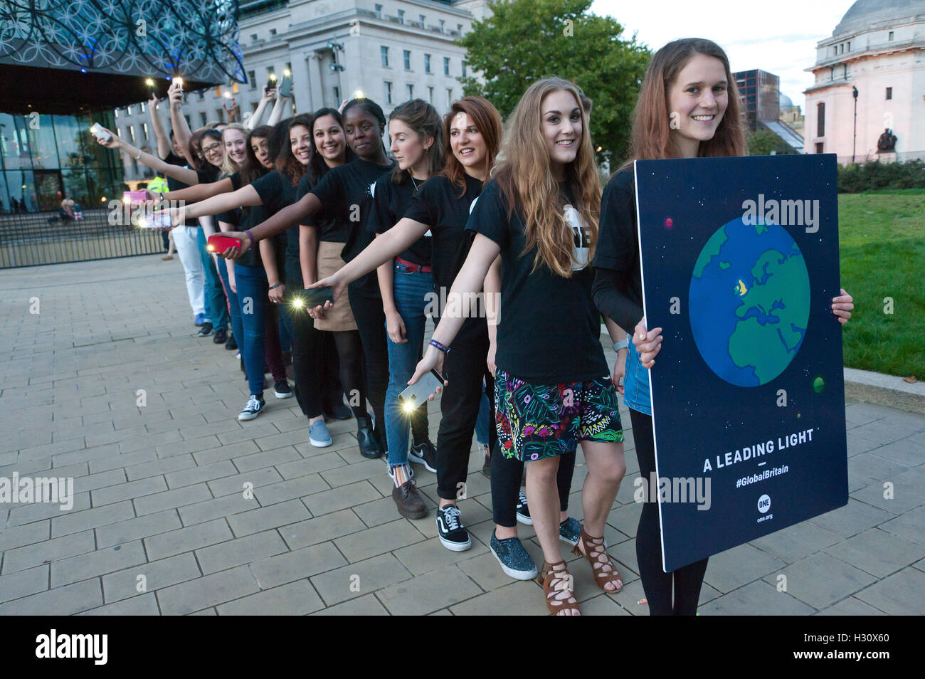 Birmingham, West Midlands, UK. 2nd October 2016. 'One' an advocacy group which campaigns for world governments to fight corruption and extreme poverty get together for a photo call outside the venue of the annual Conservative Party Conference which is being held in Birmingham, West Midlands, UK. between 2nd – 5th October 2016. Credit: Graham M. Lawrence/Alamy Live News. Stock Photo