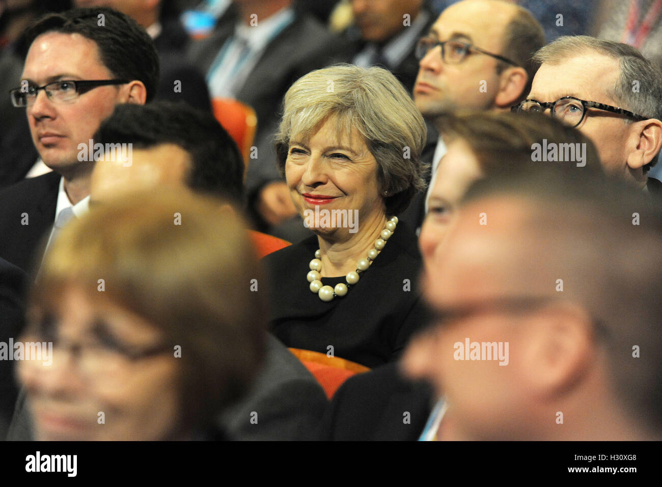 Birmingham, England. 2nd October, 2016.  Theresa May, Prime Minister and Leader of the Conservative Party listening to a speech on the first day of the Conservative Party Conference at the ICC Birmingham. The theme of the speech was 'Global Britain: Making a Success of Brexit'. This conference follows the referendum decision for the UK to leave the European Union, and the subsequent election of Theresa May as  leader of the Conservative Party. Kevin Hayes/Alamy Live News Stock Photo