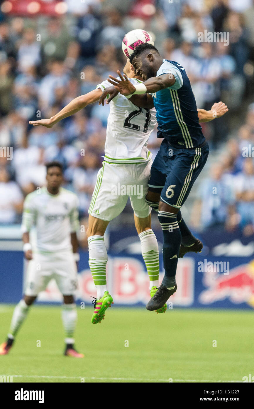 Vancouver, Canada. 2 October 2016. Jordan Smith (6) of Vancouver Whitecaps and Alvaro Fernandez (21) of Seattle Sounders jump for the ball. MLS Vancouver vs Seattle, B.C. Place Stadium. Final score Seattle 2-1. Credit:  Gerry Rousseau/Alamy Live News Stock Photo