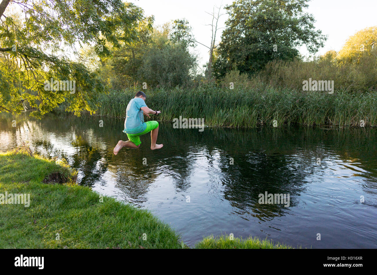 Boy jumping into river hi-res stock photography and images - Alamy