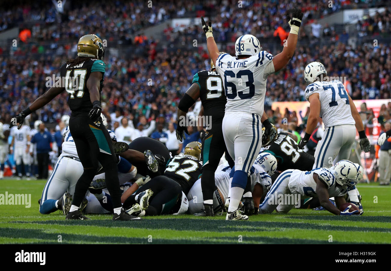 Indianapolis Colts Frank Gore (bottom right) dives in to score his side's first touchdown of the game during the NFL International Series match at Wembley Stadium, London. Stock Photo