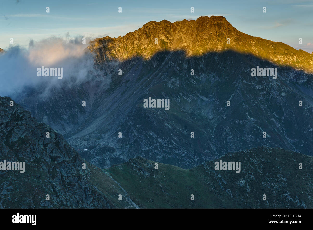 Landscape with mountain peaks at sunset in the golden hour Stock Photo ...