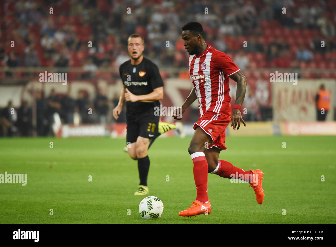 Athens, Greece. 02nd Oct, 2016. Brown Ideye (no 99) of Olympiacos attack  under the pressure of Jakob Johansson (no 18) of AEK. Triumph for  Olympiacos (red) football team, who manage to win