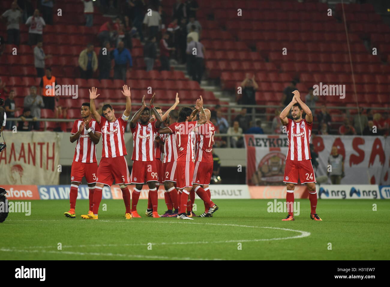 Athens, Greece. 02nd Oct, 2016. Players of Olympiacos applaud their fans at  the end of the match. Triumph for Olympiacos (red) football team, who  manage to win AEK (yellow-black) football team 3-0