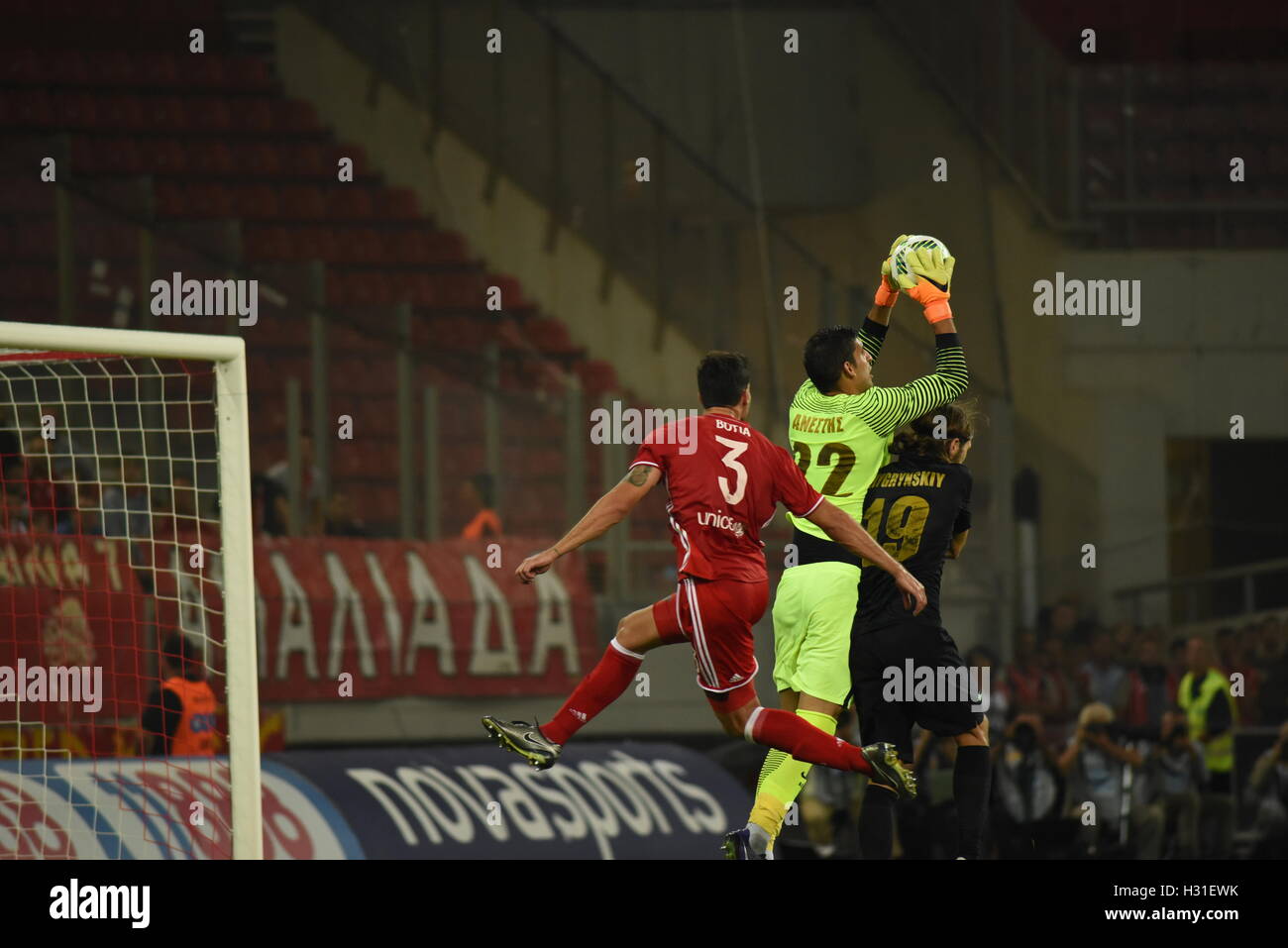 Athens, Greece. 02nd Oct, 2016. Goalkeeper Giannis Anestis (no 22) of AEK catch the ball in front of Alberto Botia (no 3) of Olympiacos and of Dmytro Chygrynskyy (no 19) of AEK. Triumph for Olympiacos (red) football team, who manage to win AEK (yellow-black) football team 3-0 for the Greek Super League. Credit:  Dimitrios Karvountzis/Pacific Press/Alamy Live News Stock Photo
