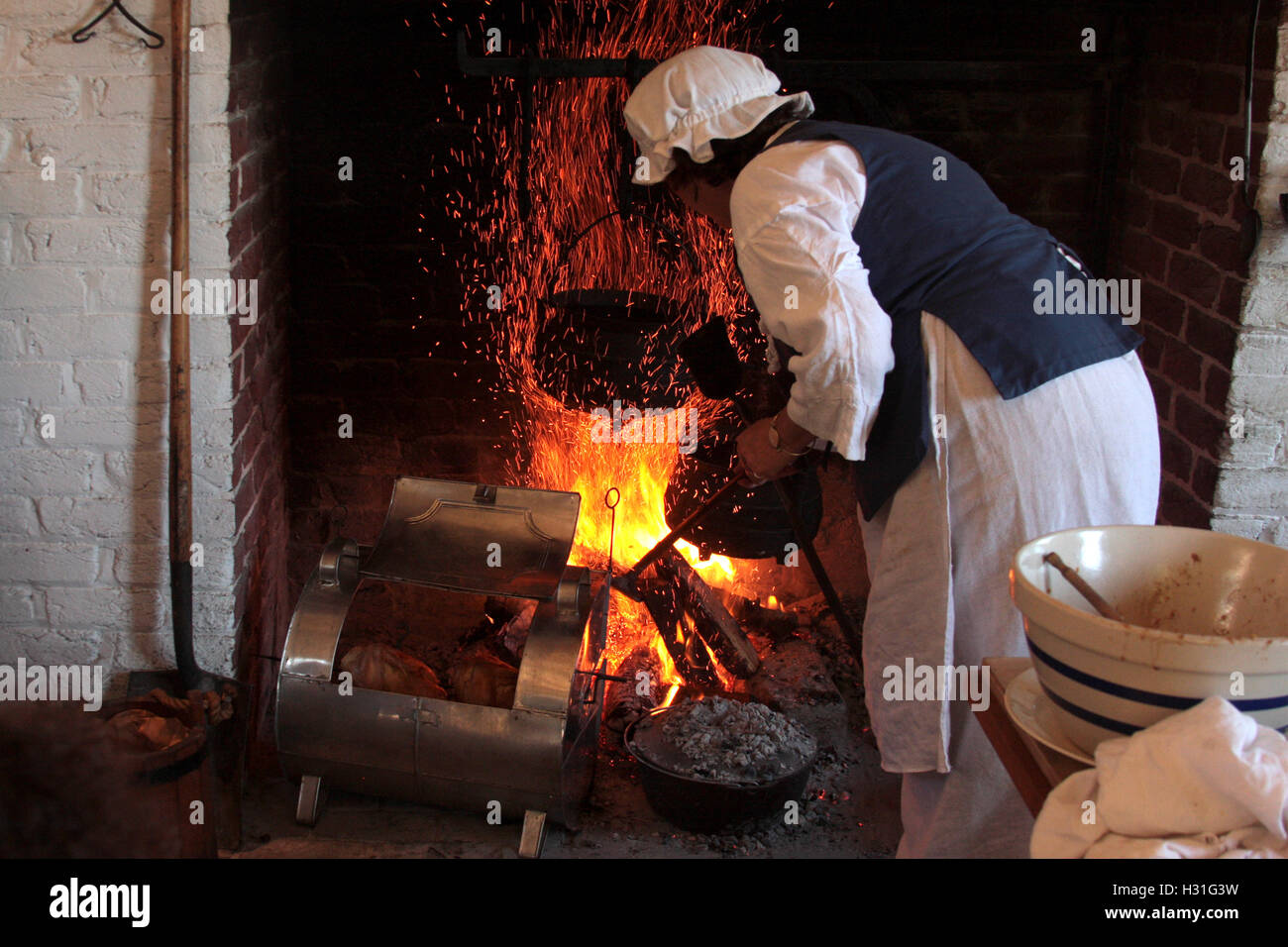 Demonstration Of Old Style Cooking In Fireplace Stock Photo