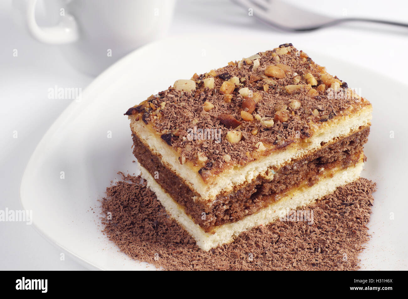 Cake with chocolate in white plate closeup Stock Photo - Alamy