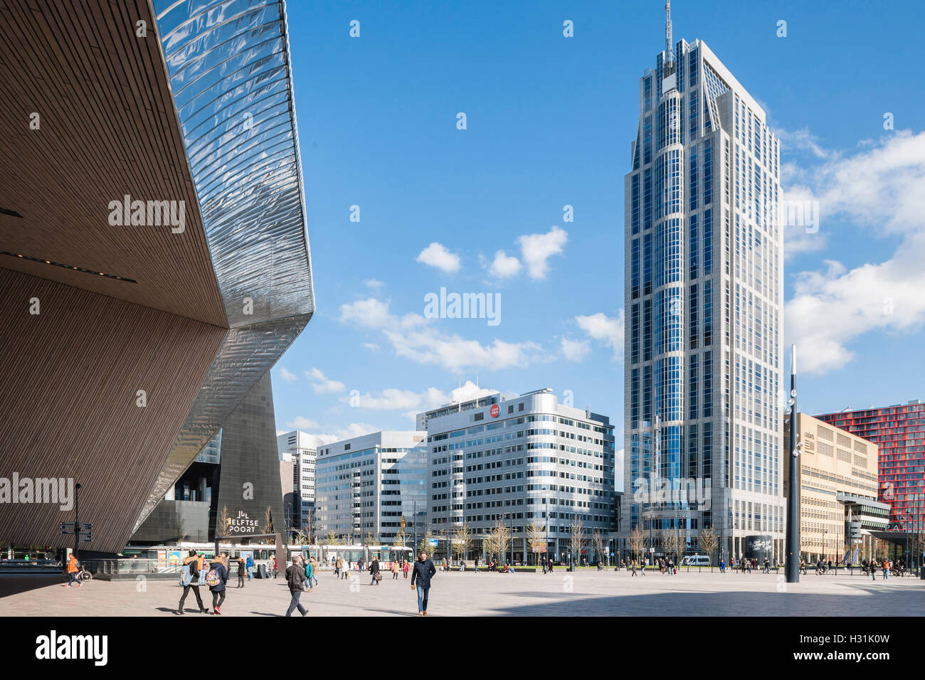 Main entrance angular view of metal clad canopy, high-rise buildings and public plaza. Centraal Station, Rotterdam, Netherlands. Architect: Benthem Crouwel Architects + MVSA Architects + Wes, 2014. Stock Photo