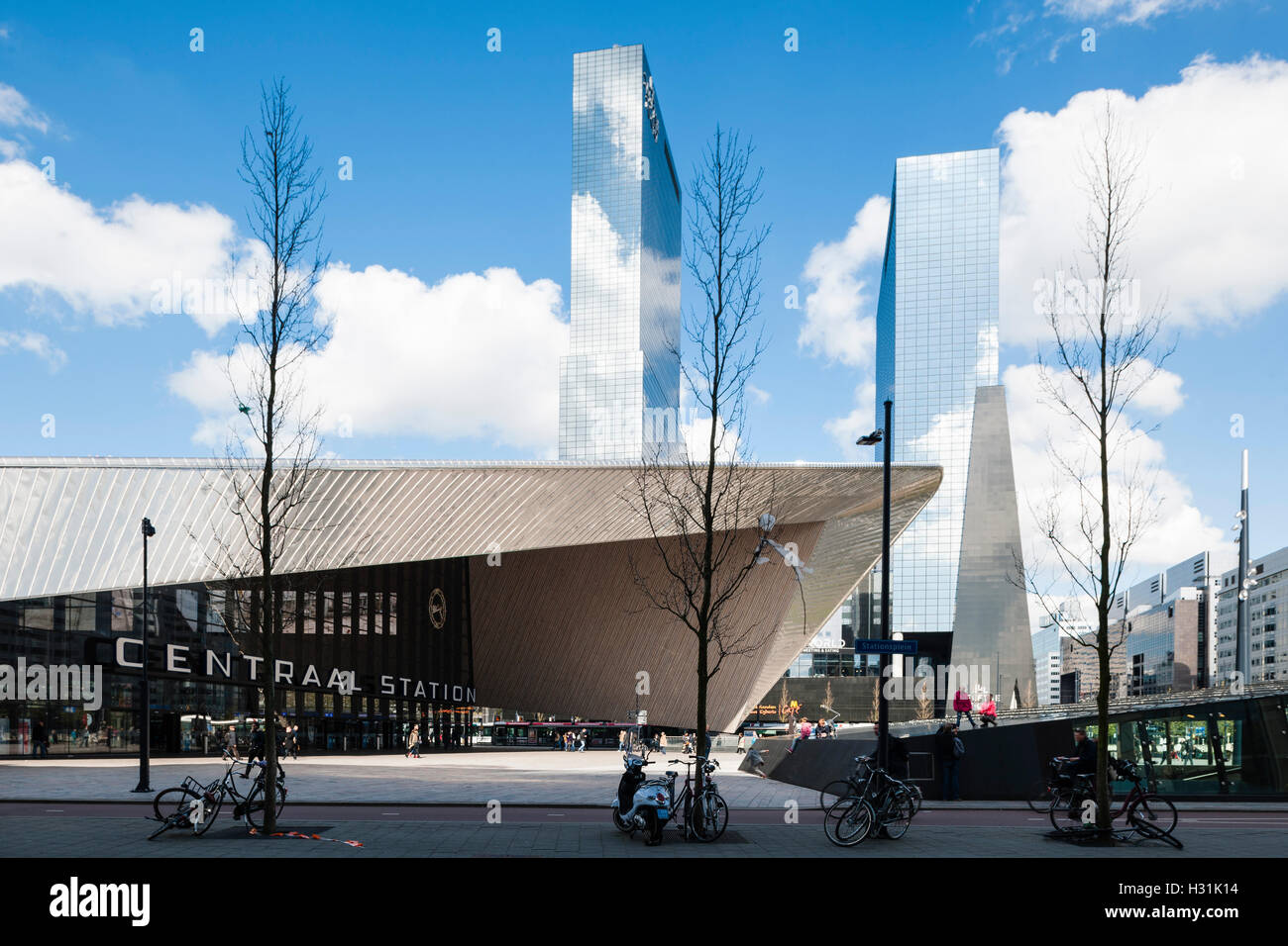 View of public plaza and angular metal-clad canopy with pedestrians. Centraal Station, Rotterdam, Netherlands. Architect: Benthem Crouwel Architects + MVSA Architects + Wes, 2014. Stock Photo