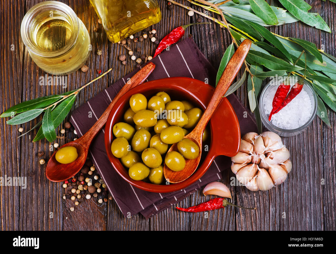 green olives in bowl and on a table Stock Photo Alamy