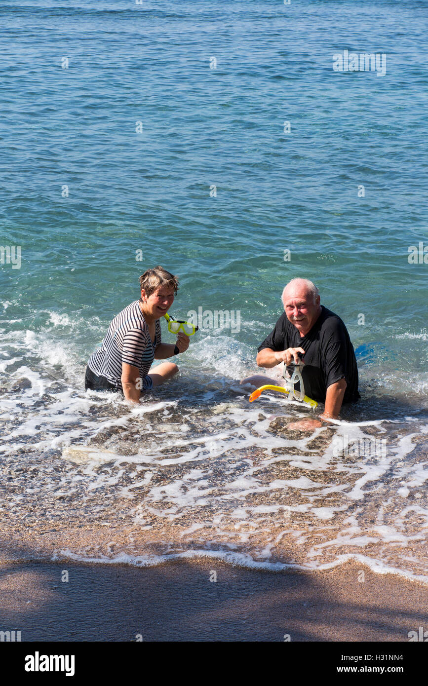 Indonesia, Bali, Amed, snorkeling, man and woman tourist snorkellers sat in  sea Stock Photo - Alamy