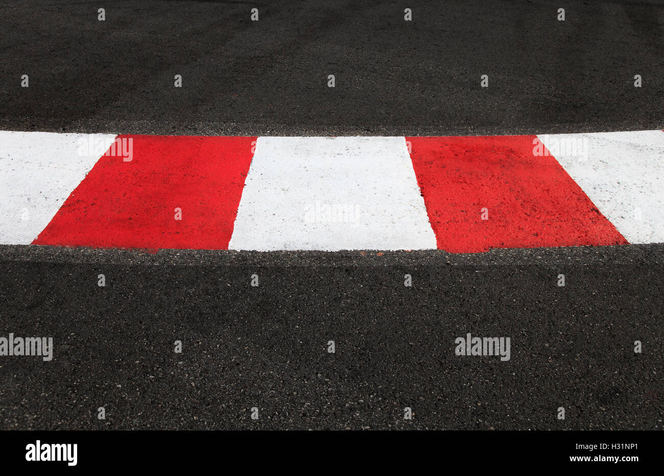 Texture of motor race asphalt and re white curb. Close up on Monaco Montecarlo Grand Prix street circuit Stock Photo