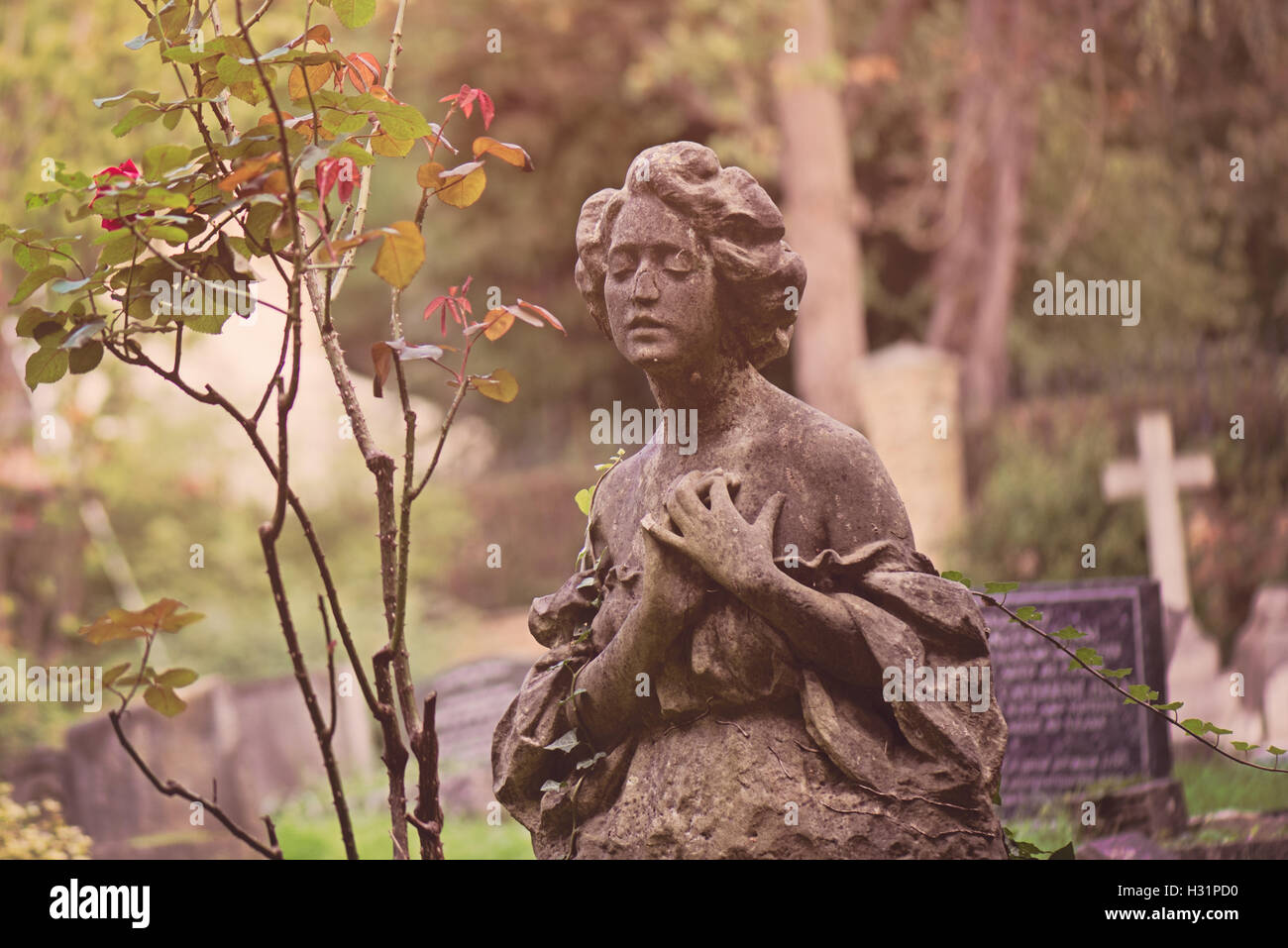 Gravestone tombstone statue of a woman in deep sorrow at Highgate Cemetery East in London, England. Stock Photo