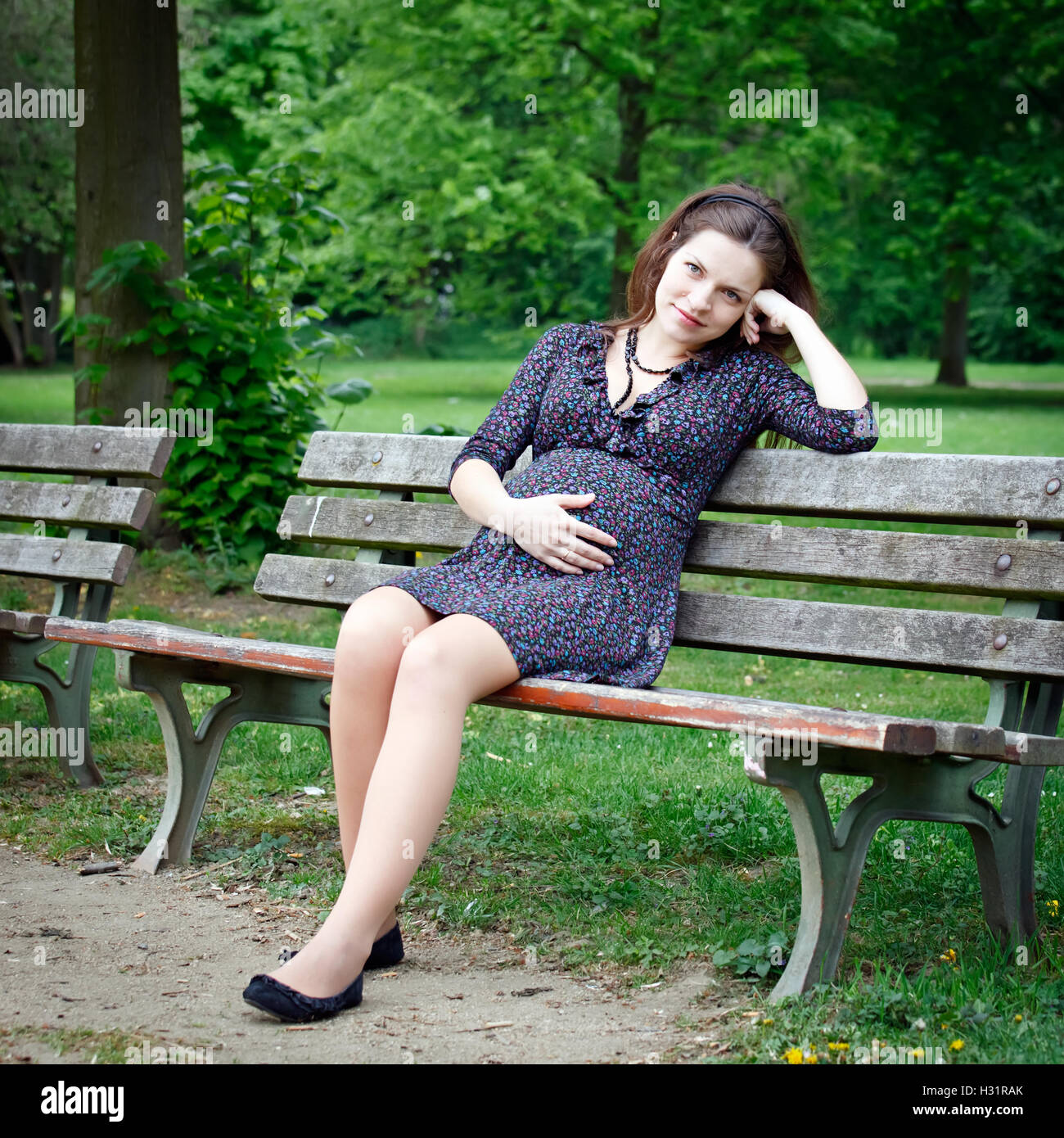 Pregnant woman relaxing in the park Stock Photo - Alamy