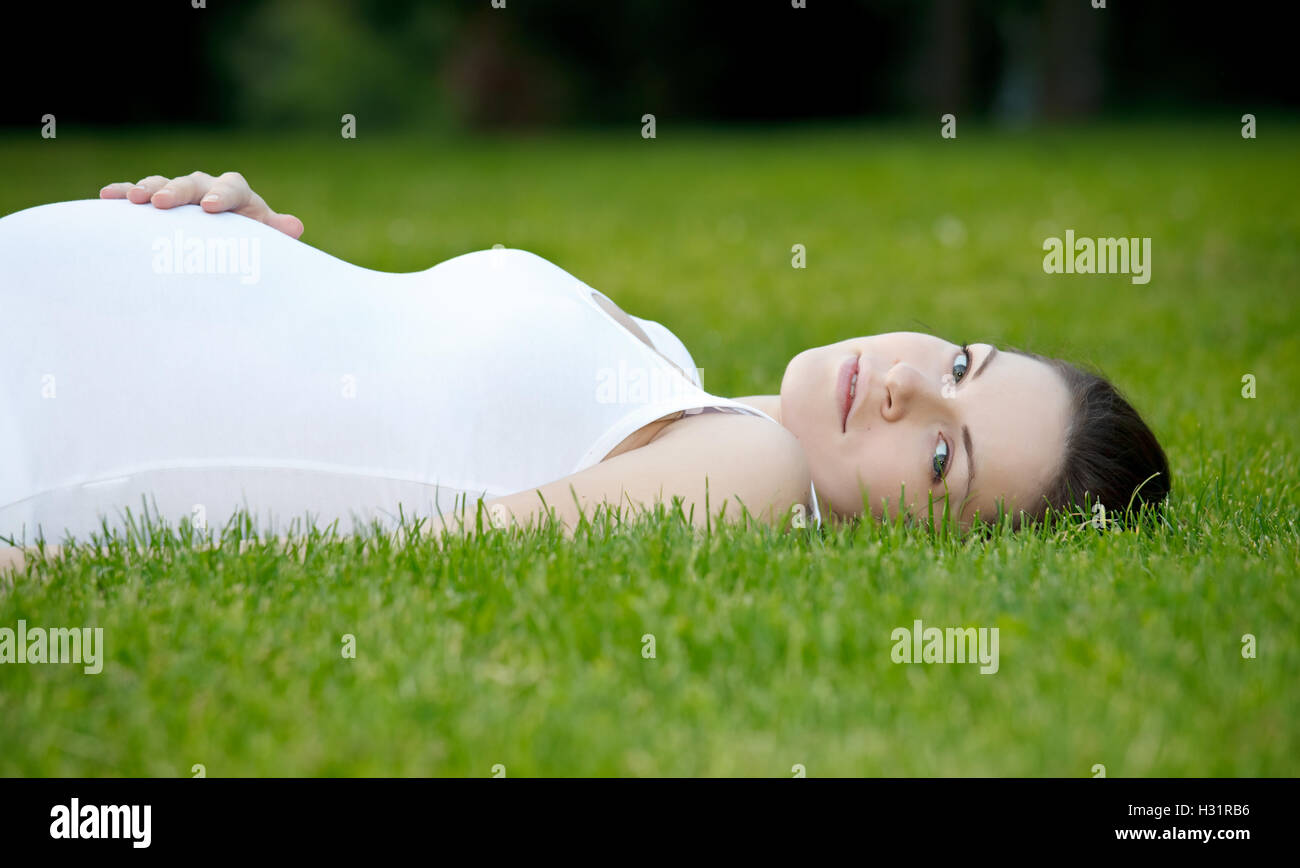 Beautiful pregnant woman in the park Stock Photo - Alamy
