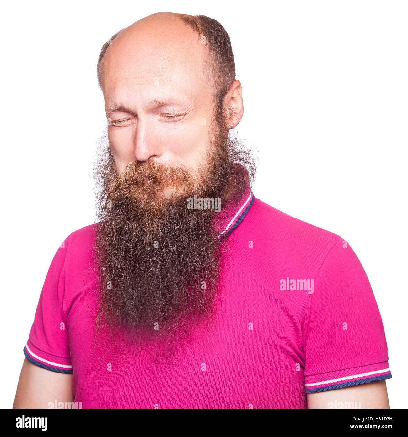 Portrait of a sad bald, bearded man crying, isolated on white background. Stock Photo