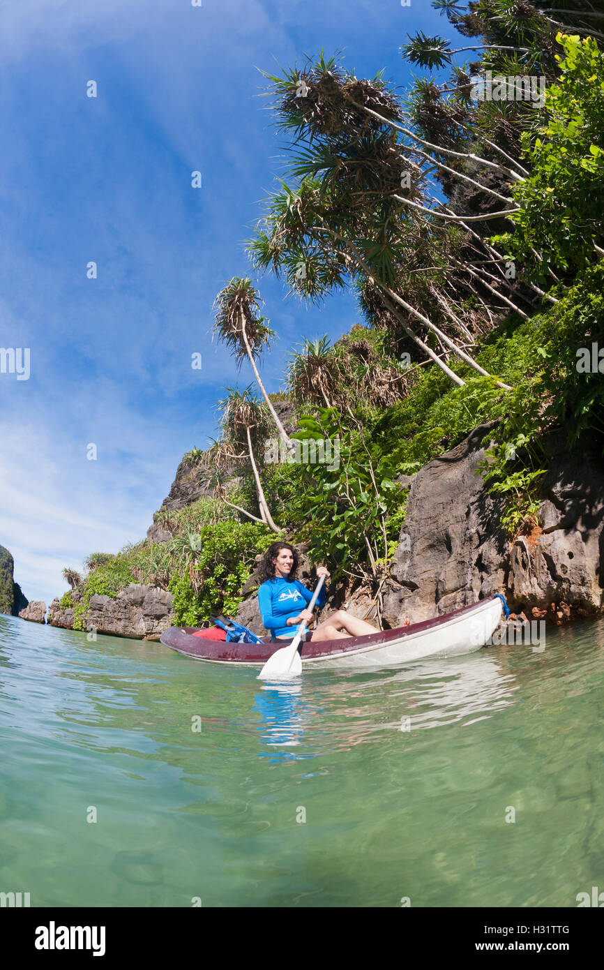 woman (model released) explores karst islands by kayak during surface interval between scuba dives. Indonesia, tropical Indo-Pac Stock Photo