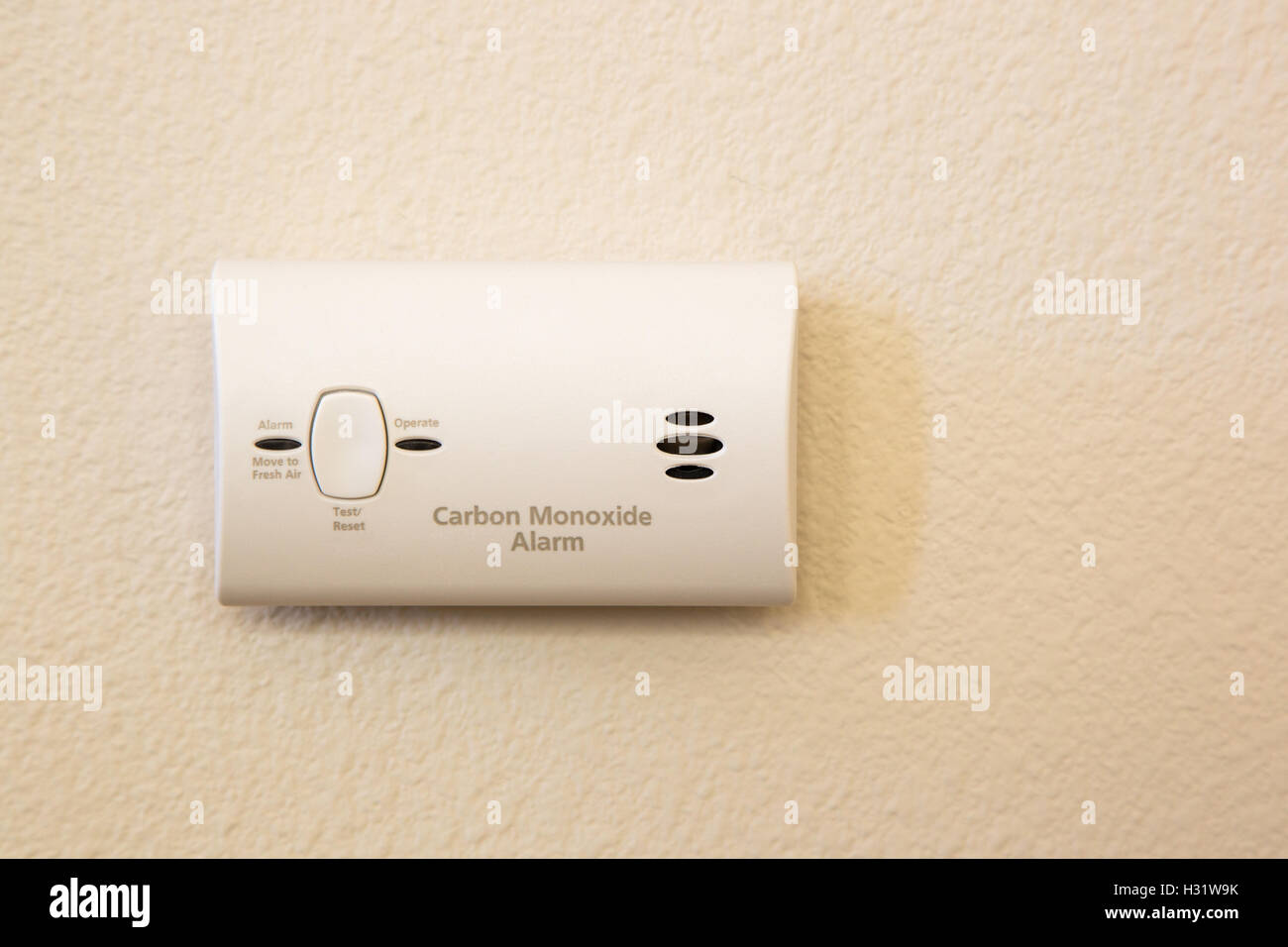 Carbon Monoxide Alarm Attached to Wall in House. Stock Photo
