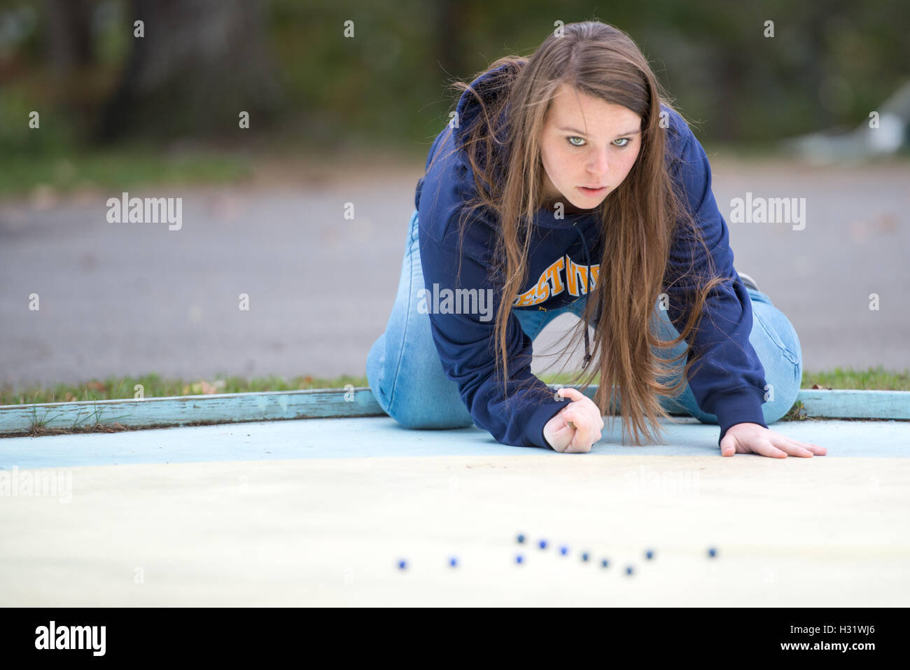 Girl playing with marbles in  Cumberland, Maryland. Stock Photo