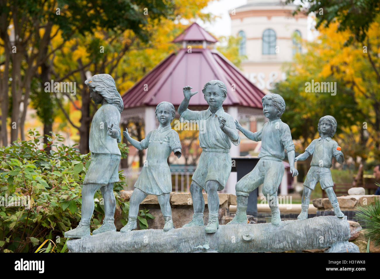 Outdoor sculpture of children playing on a log in Arlington, Virginia. Stock Photo
