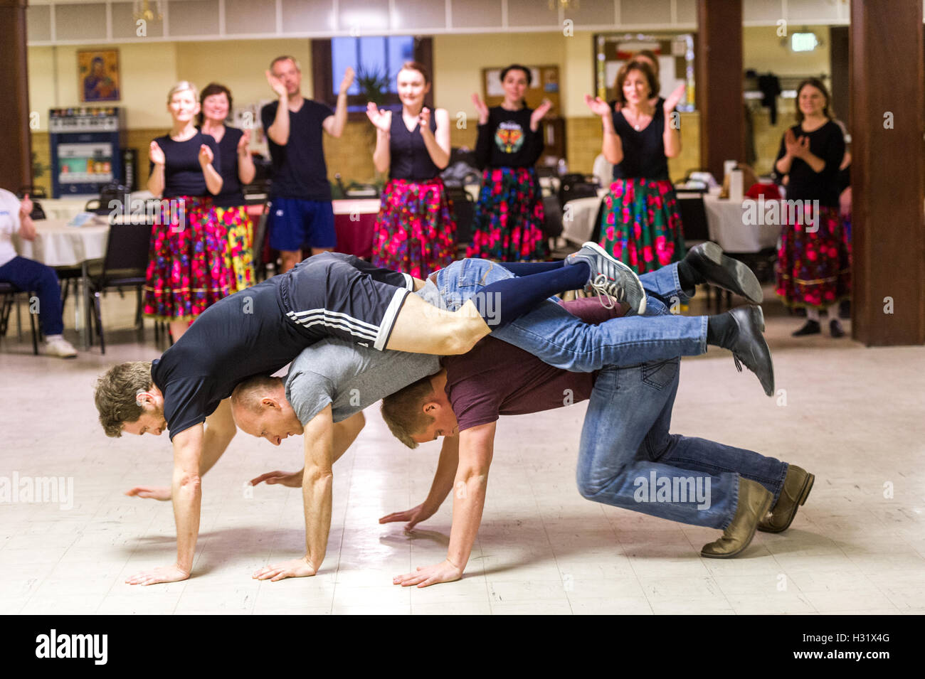 Men performing traditional movements of Polish Dancing Stock Photo