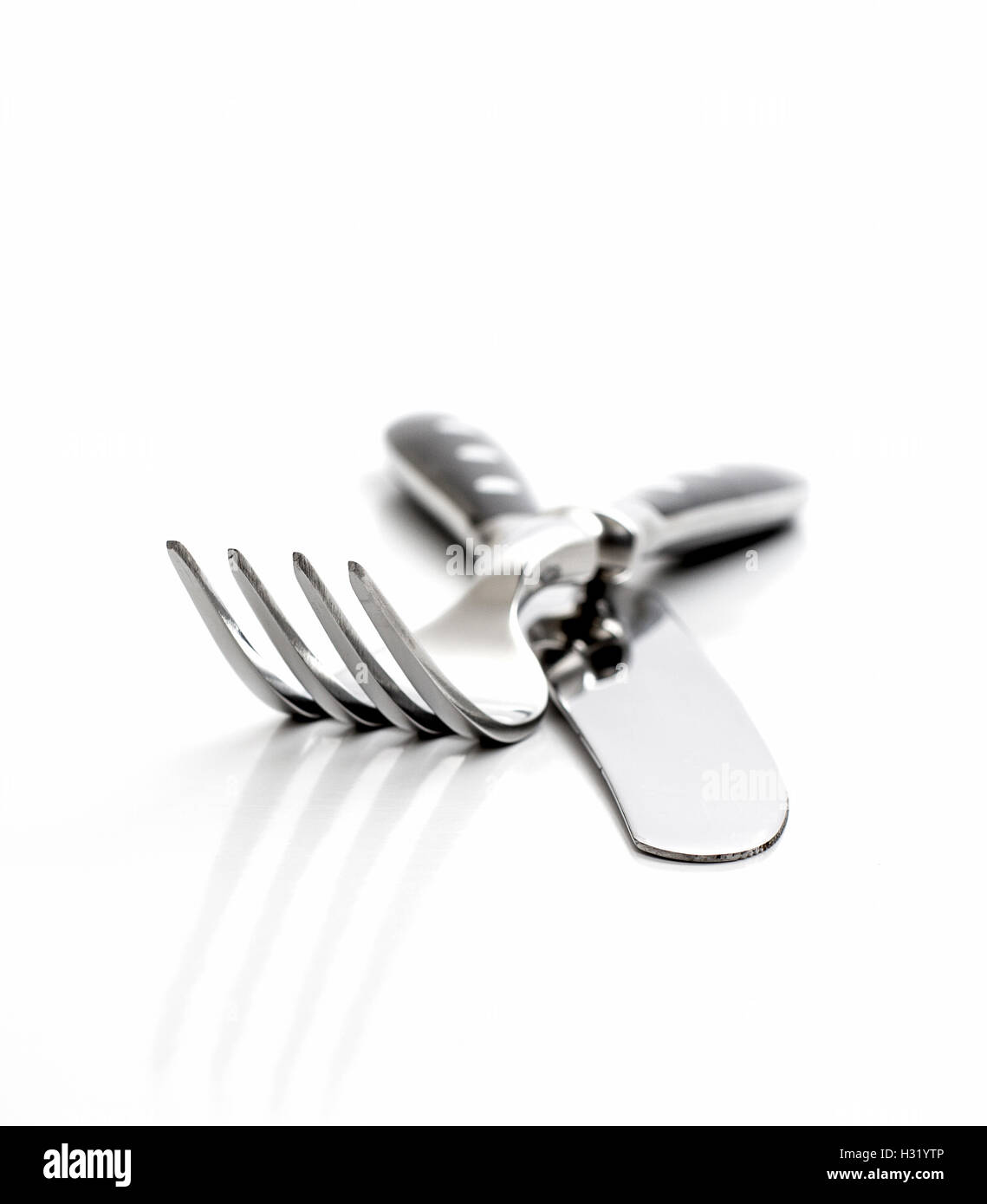 Cutlery, fork with knife isolated on white, close up Stock Photo