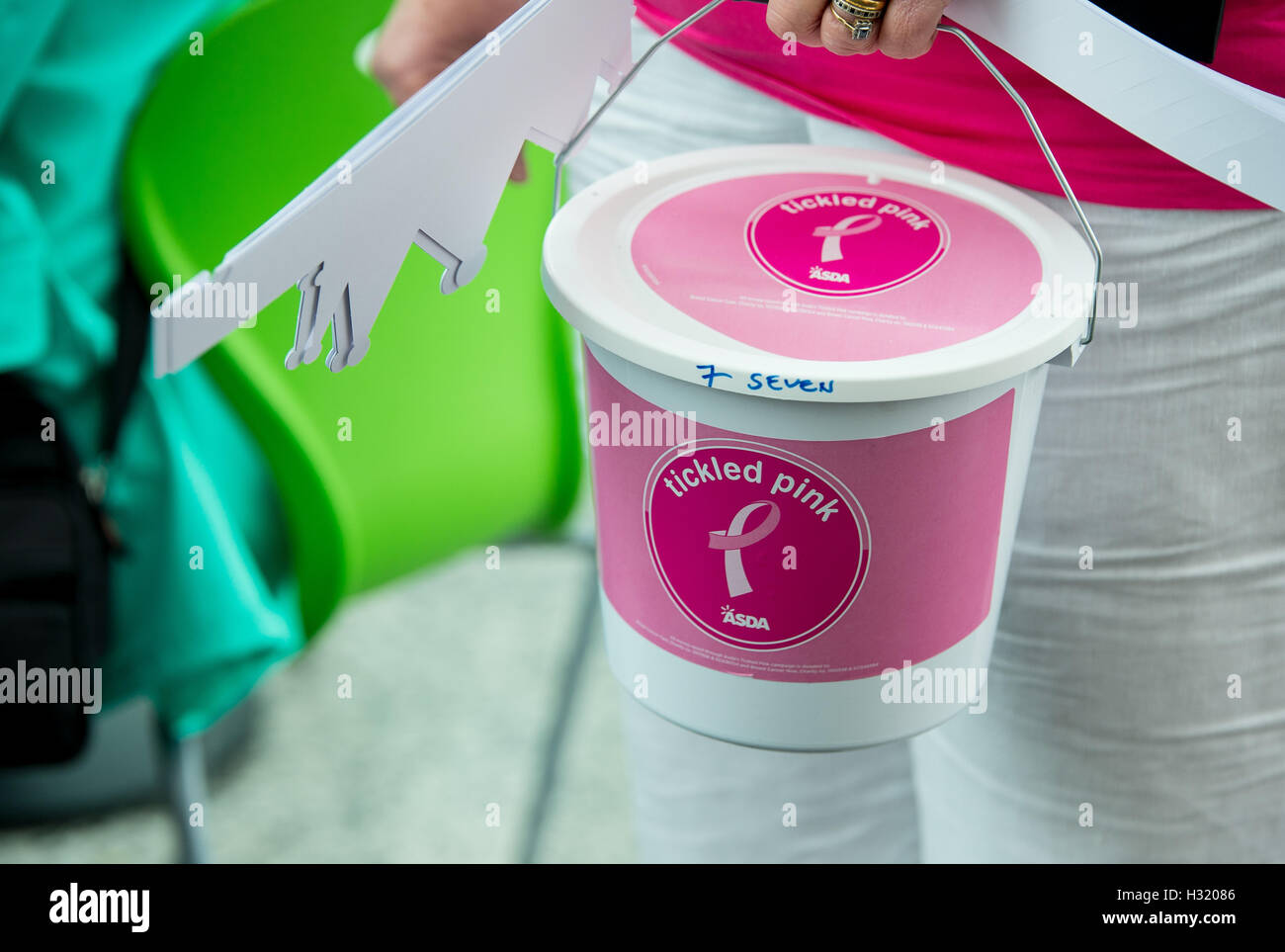 Asda tickled pink buckets held by staff at the store in Hollingbury, Brighton, Sussex, UK Stock Photo