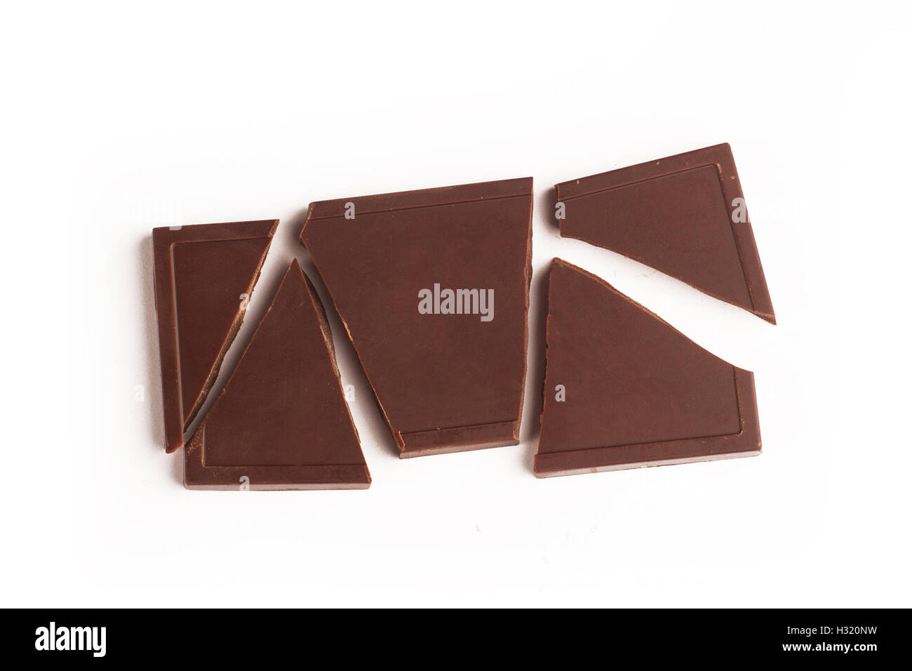 Top view of broken chocolate bar pieces isolated on white background