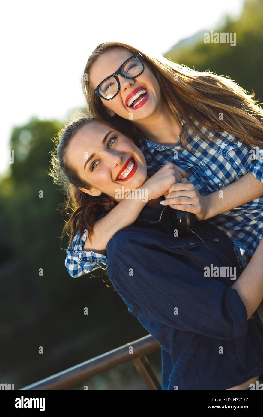 Two playful young women having fun outdoors at sunset light Stock Photo ...