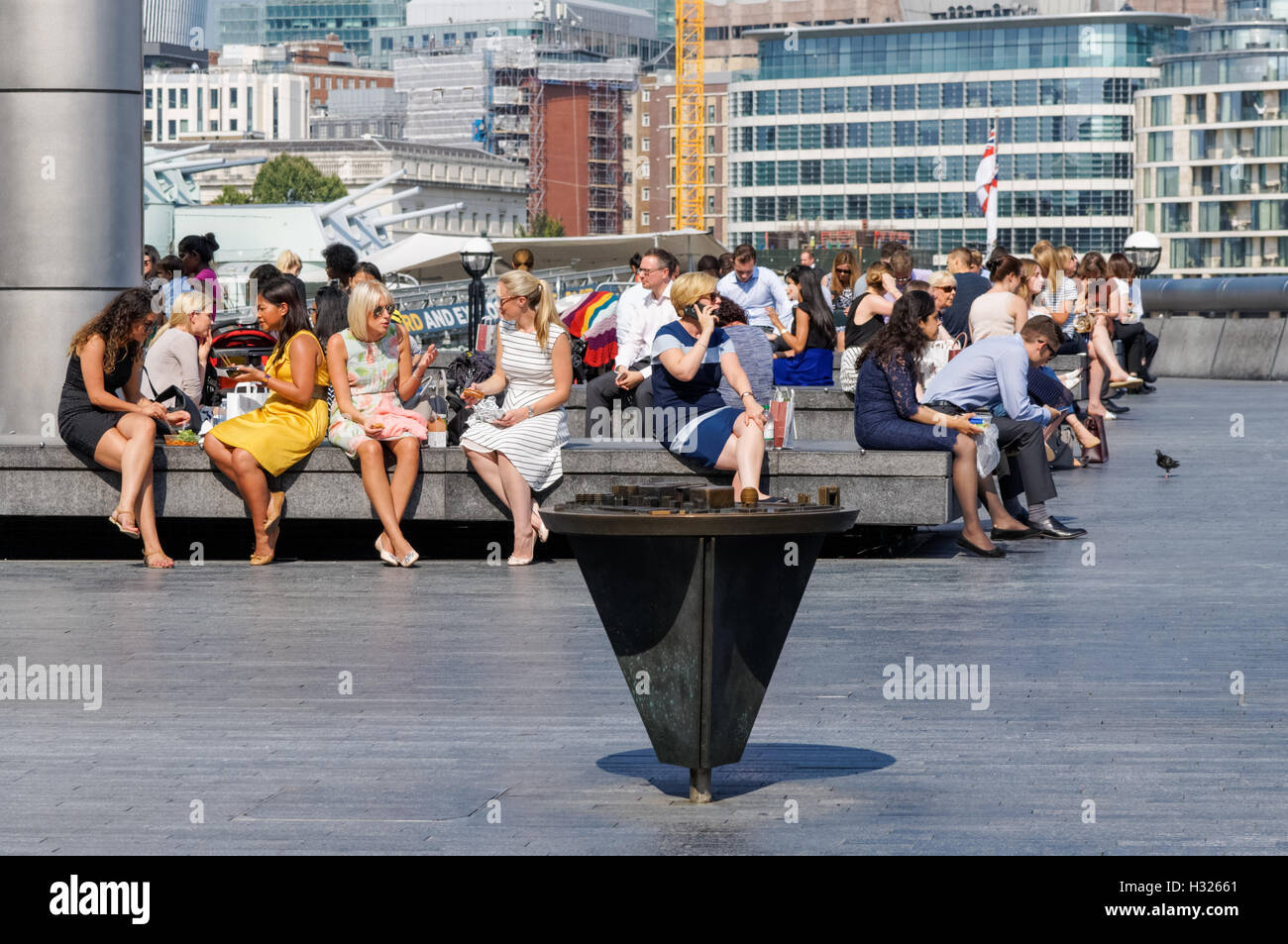People enjoying sunny weather at More London Riverside, London England United Kingdom UK Stock Photo
