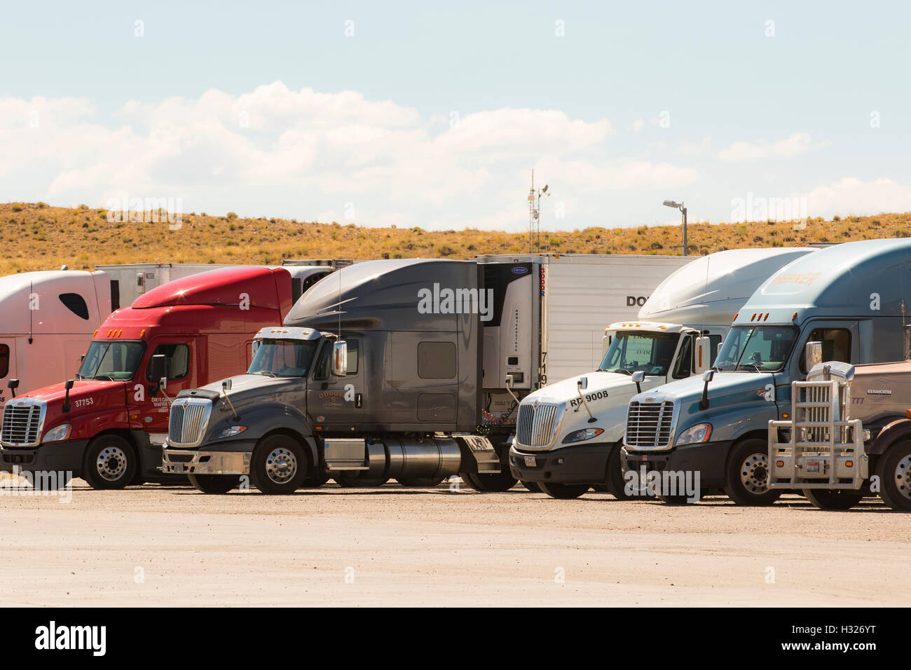 Truck stop, truckstop with semi truck, trucks lined up in parking lot. Stock Photo