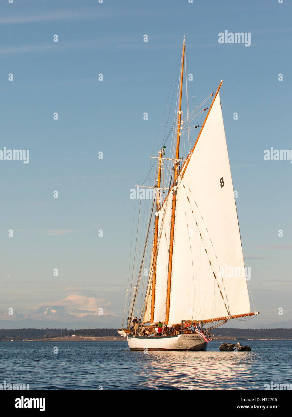 Sailing boat, sailboat wooden boat schooner Zodiac sailing Port Townsend bay, Puget Sound with Mount Baker in background. Stock Photo