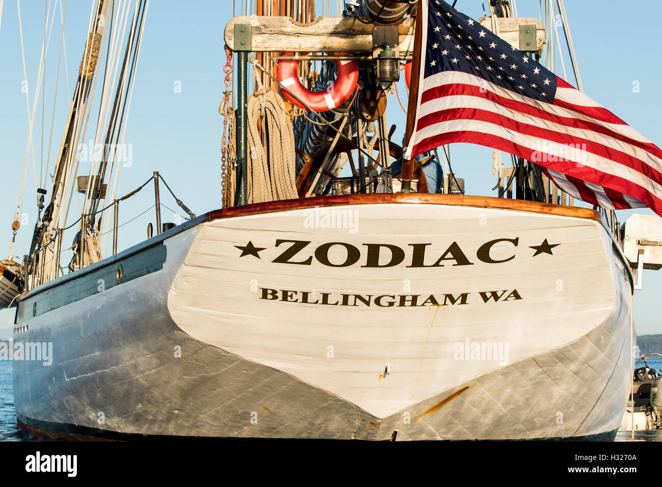 American flag on the sailboat stern of the wooden boat schooner Zodiac in Port Townsend bay during the Wooden Boat Festival. Stock Photo