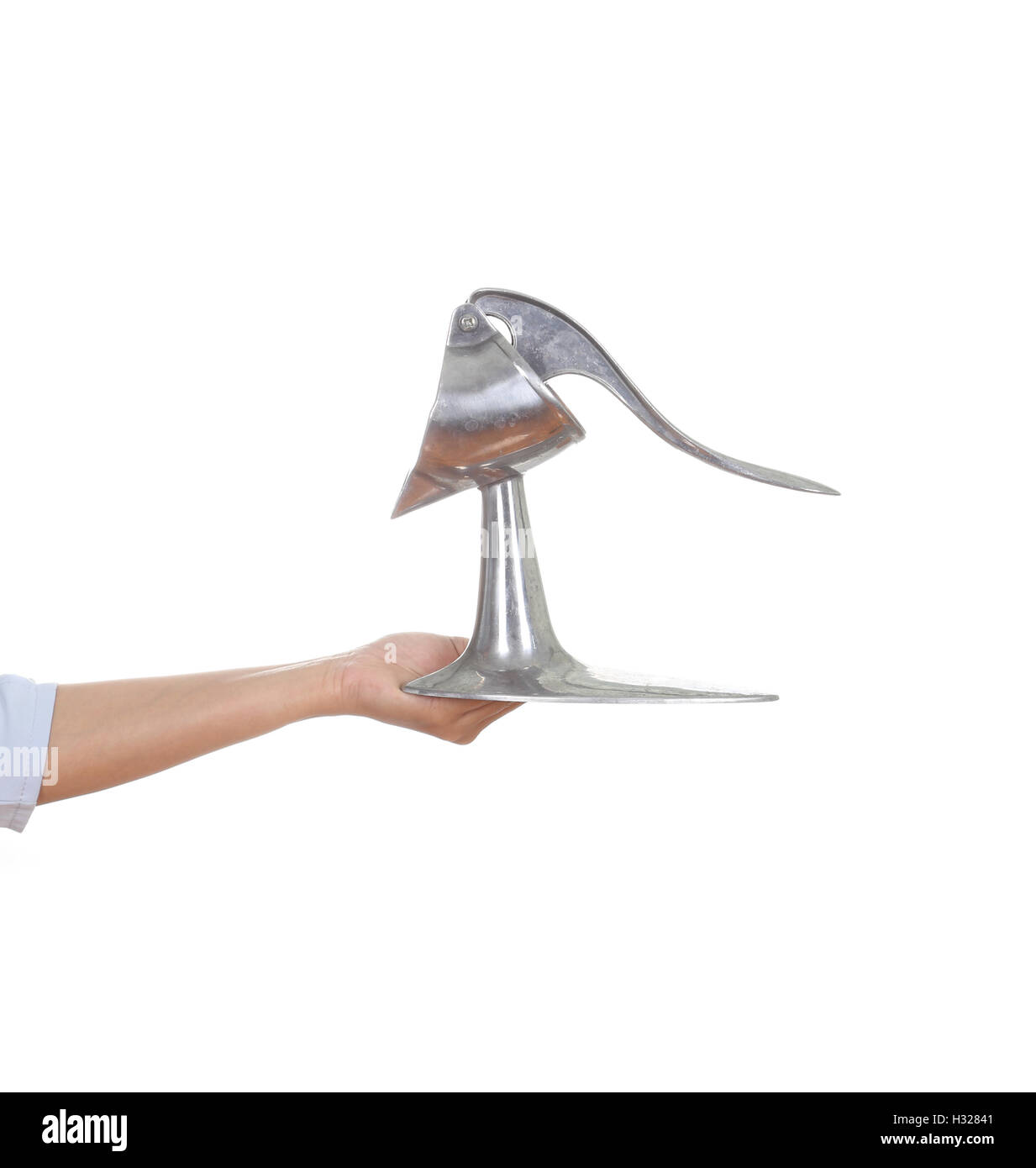 hand with vintage crush stainless orange juicer Stock Photo Alamy