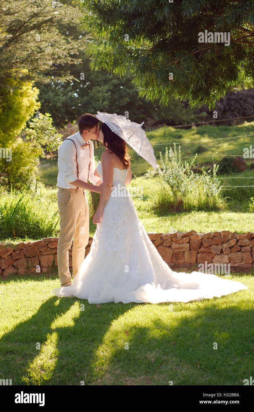 Bride and groom kissing in garden wedding Stock Photo - Alamy