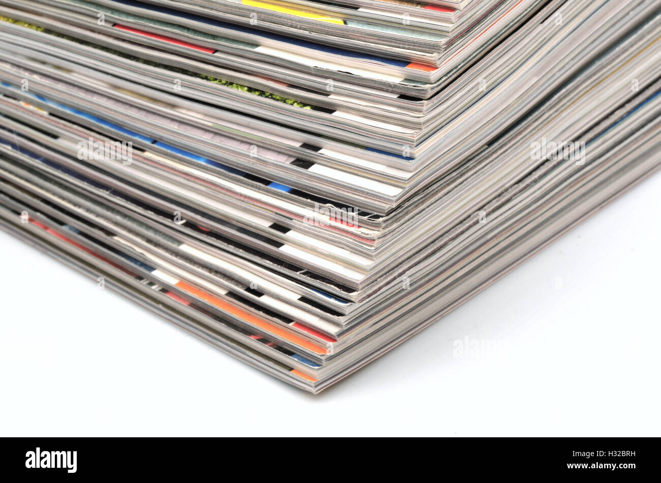 Stack of old colored magazines on white background Stock Photo