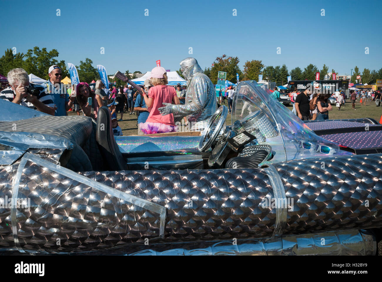 Peter Jarvis creates an entertainer called silver Elvis pictured with his unique silver car at the 2016 Toronto buskerfest. Stock Photo