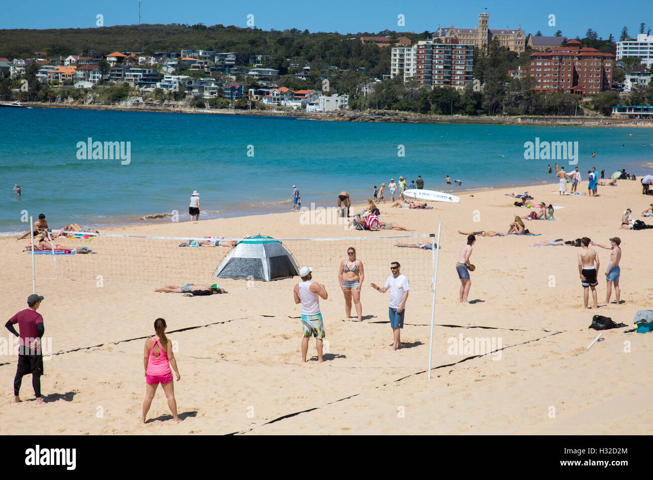 adults playing beach volleyball on Manly Beach,Sydney,Australia Stock Photo