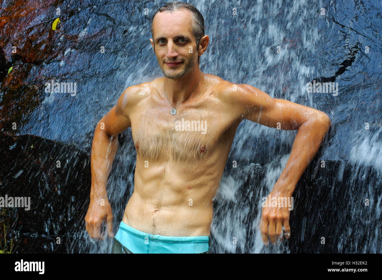 Man bathing under waterfall hires stock photography and images Alamy