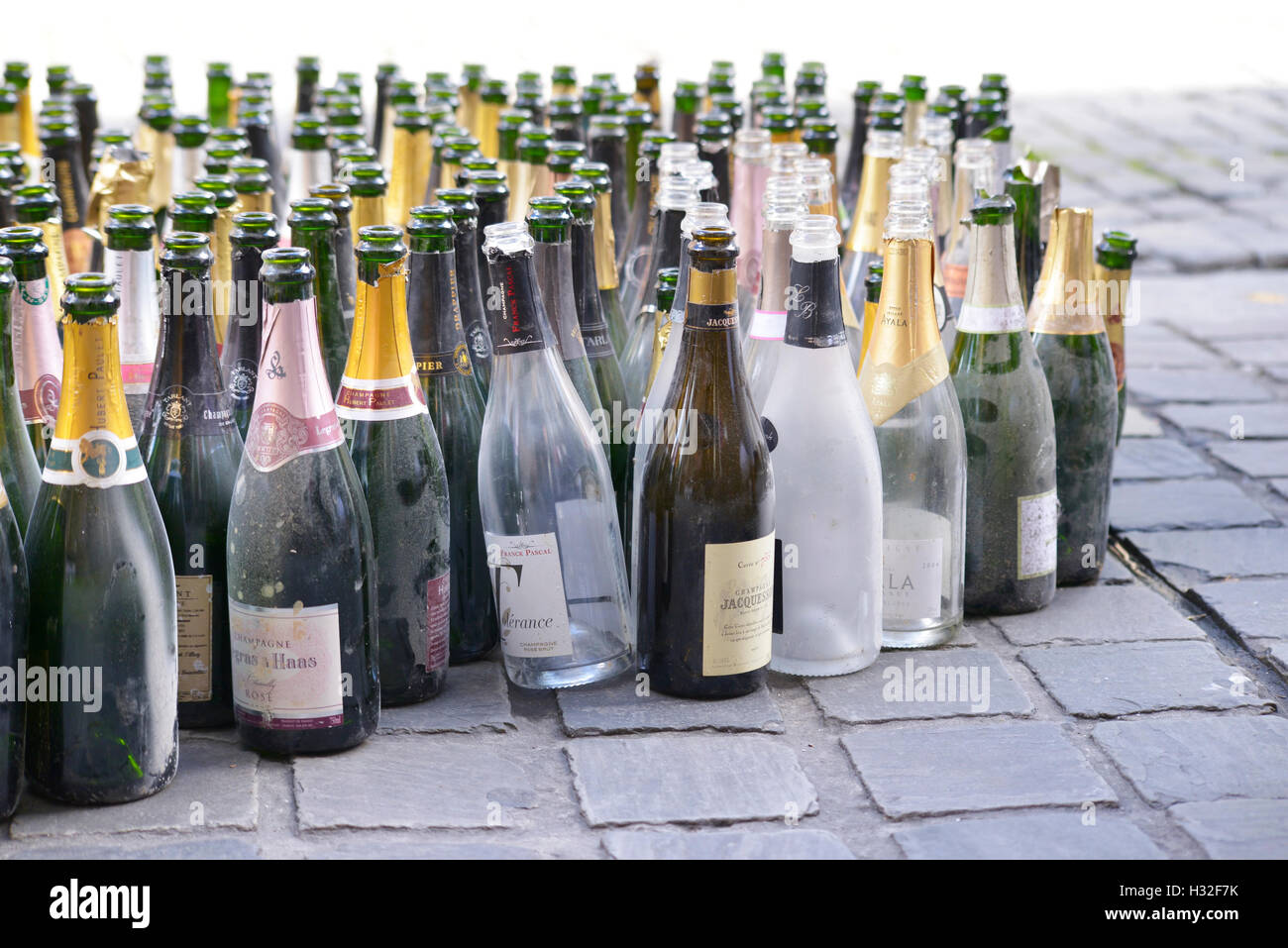 Empty wine bottles prepared for collection by cleaning service on