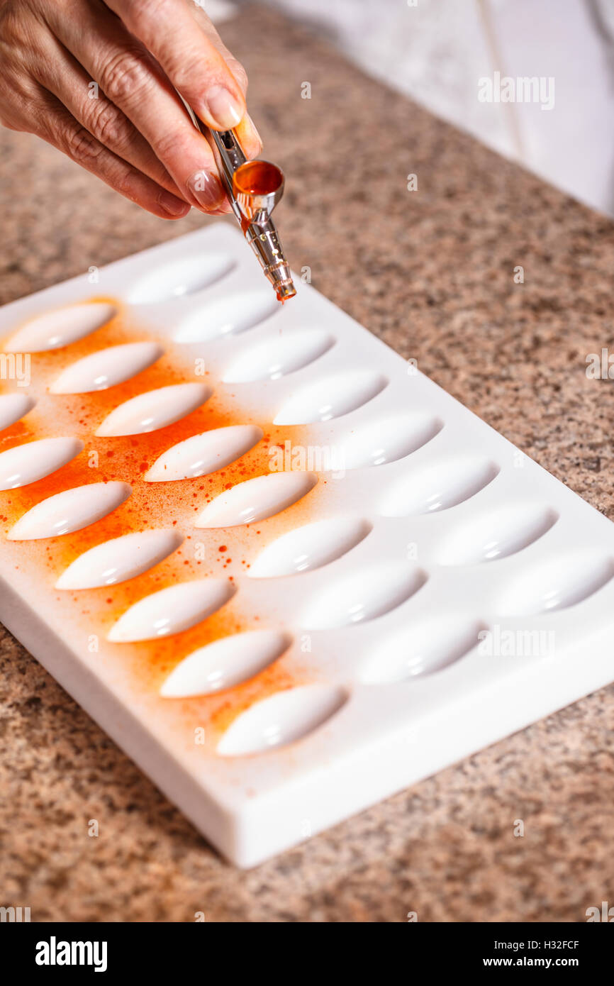Making chocolate candies in mold Stock Photo Alamy