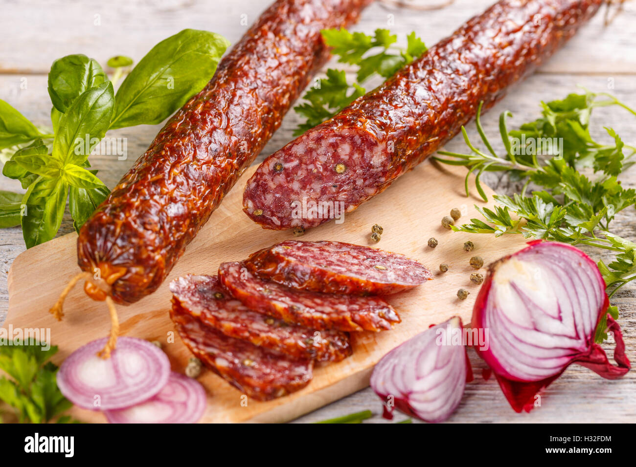 Smoked sausage salami with green peppercorns Stock Photo