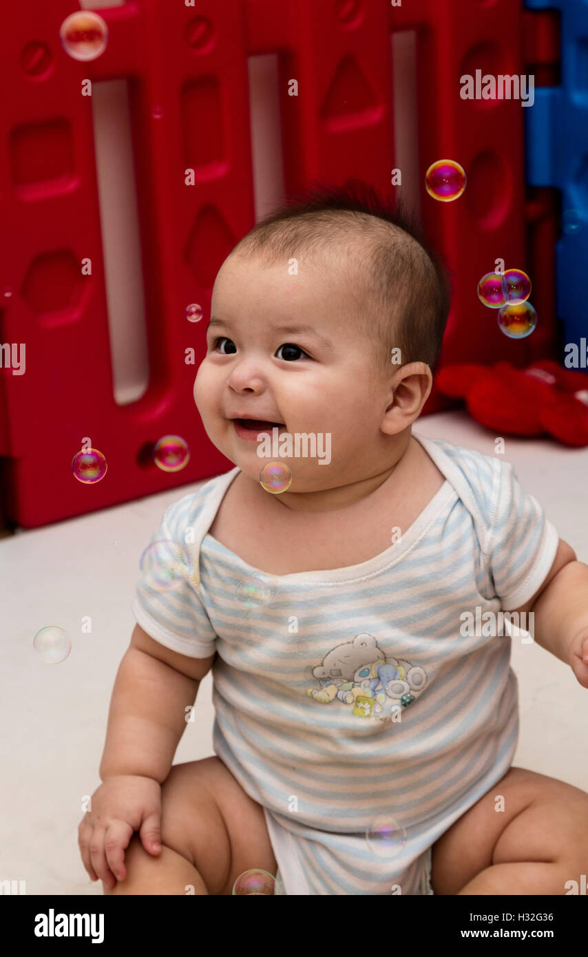 Baby Laughing At Bubbles Stock Photo Alamy