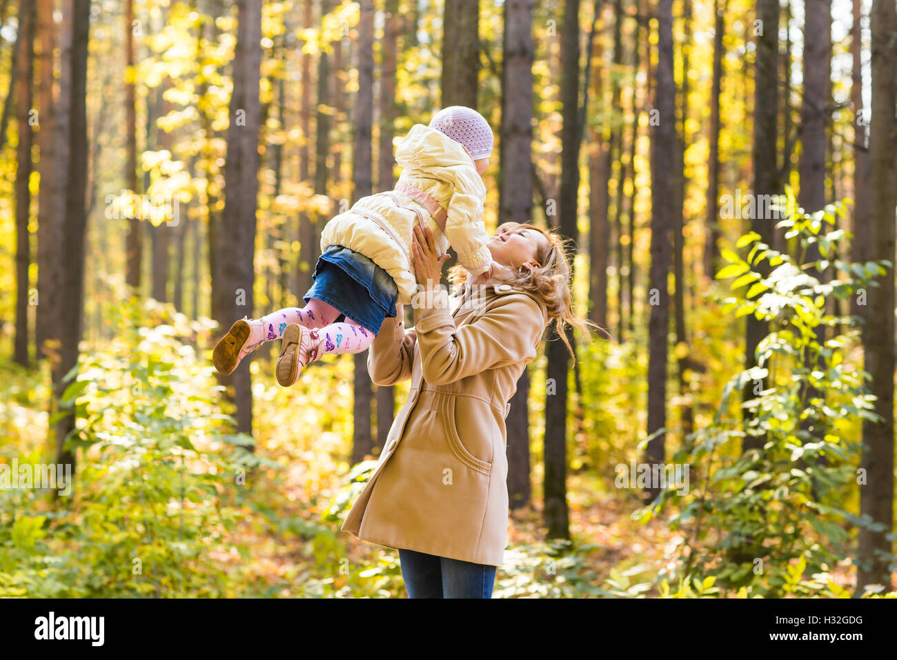 mother and daughter playing together in the autumn park Stock Photo - Alamy
