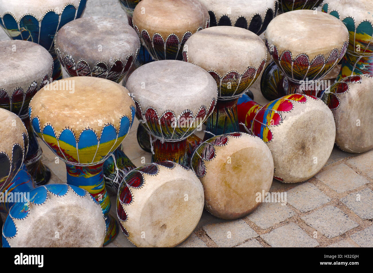Many colorful congas or hand-drums for sale in a handicraft market Stock Photo