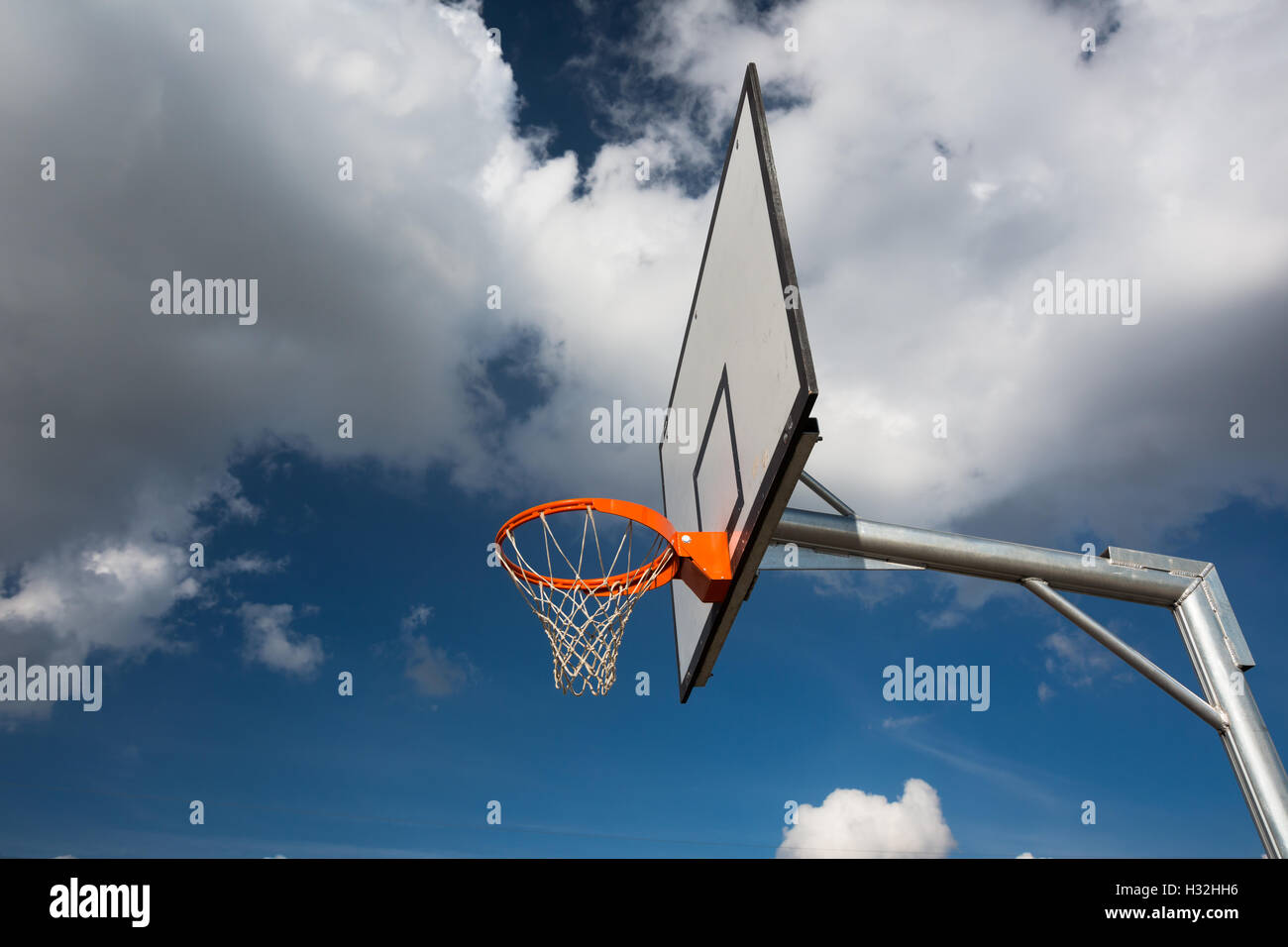 Basketball hoop against  lovely blue summer sky Stock Photo